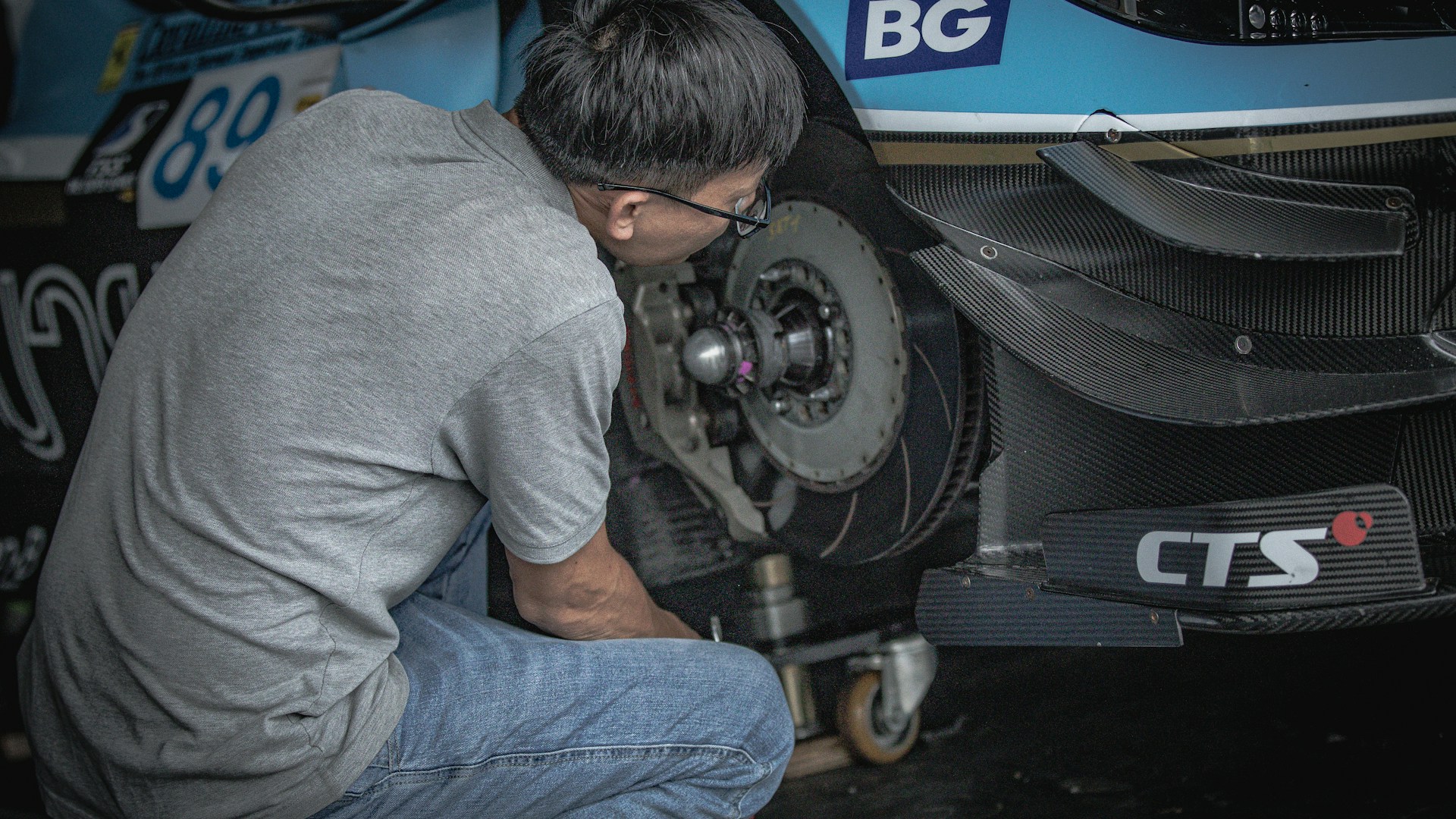 Real mechanic performing brake service